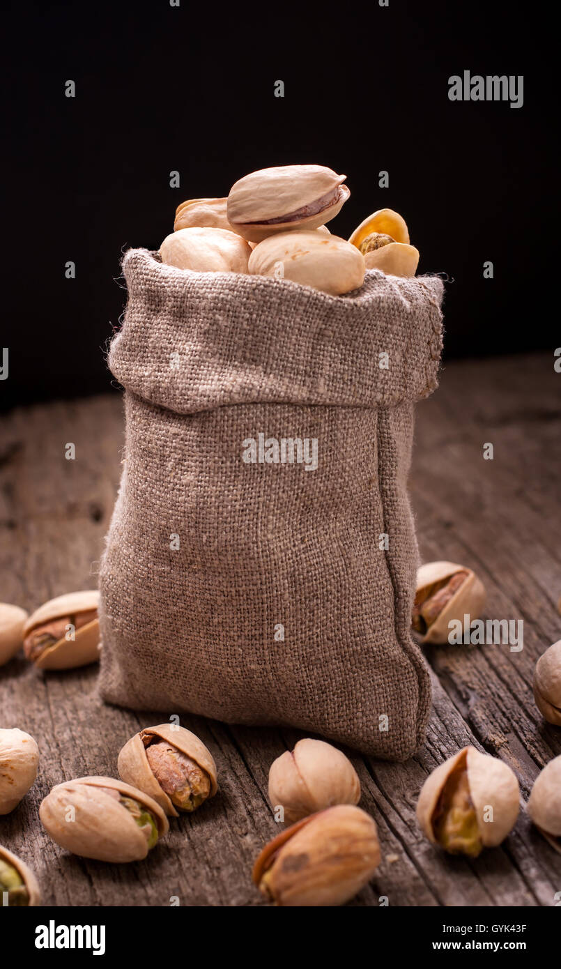 Bag of pistachios on dark Stock Photo