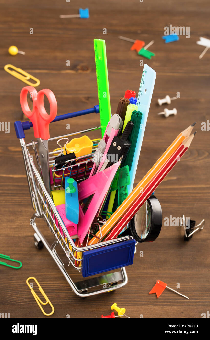 Stationery items in shopping trolley above Stock Photo