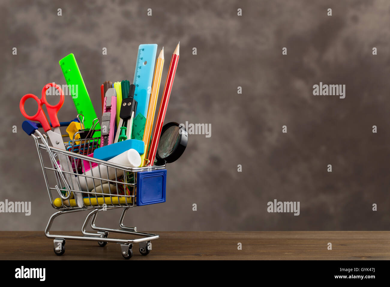 Stationery items in shopping trolley at left side Stock Photo