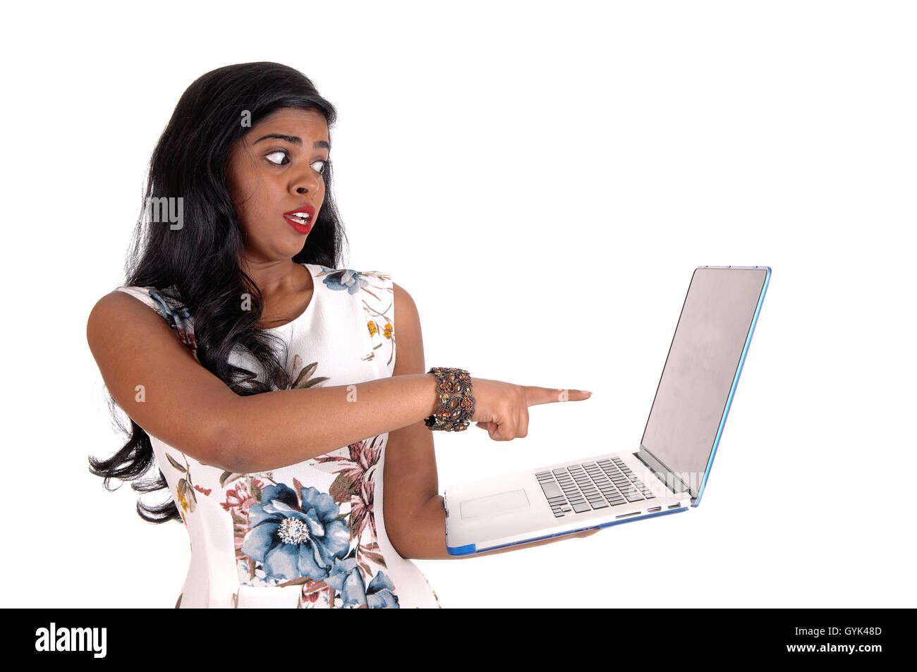 A scared Indian woman looking scared at her laptop what she see's at  the screen, isolated for white background. Stock Photo