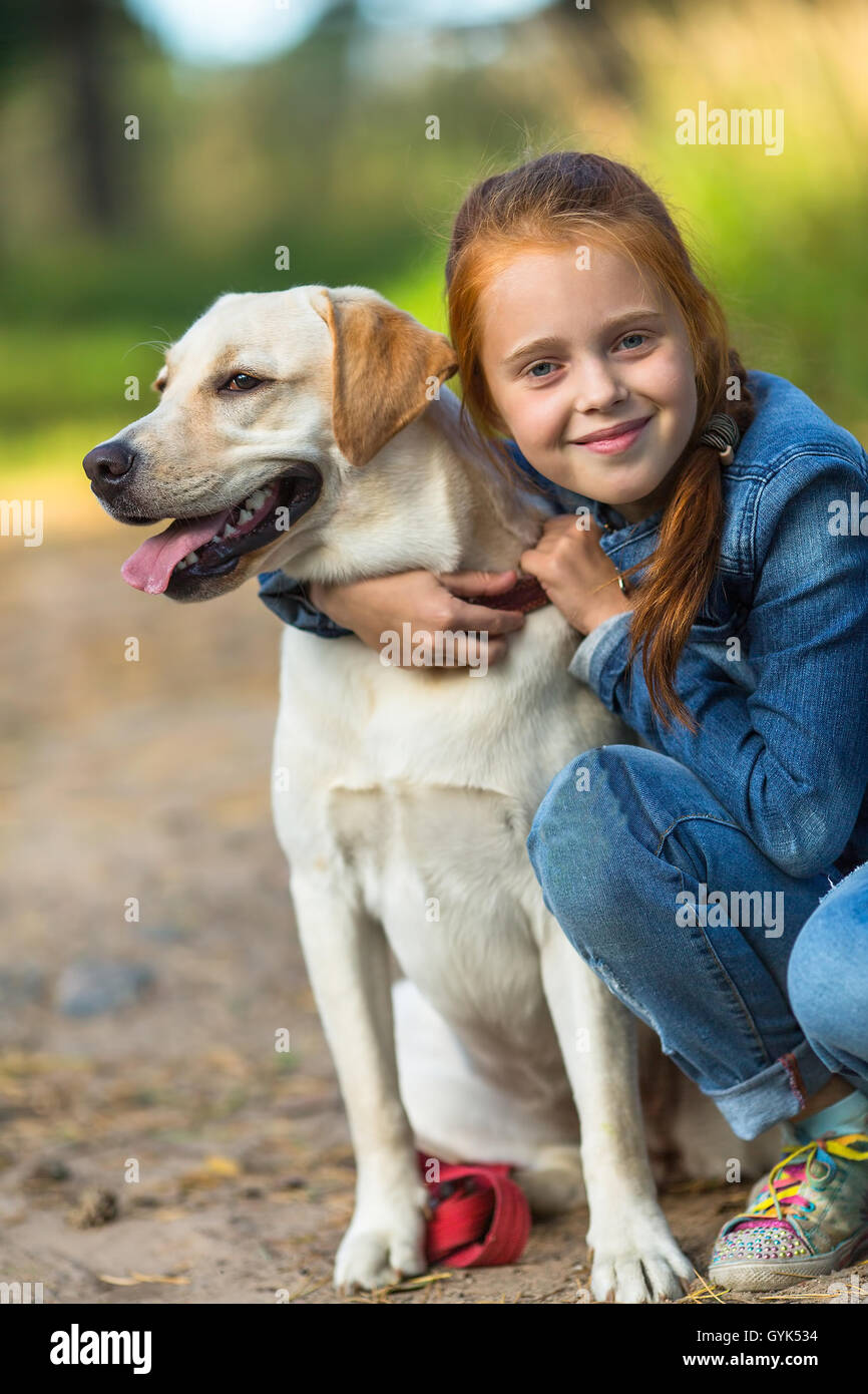 Little girl on a walk with the dog. Stock Photo