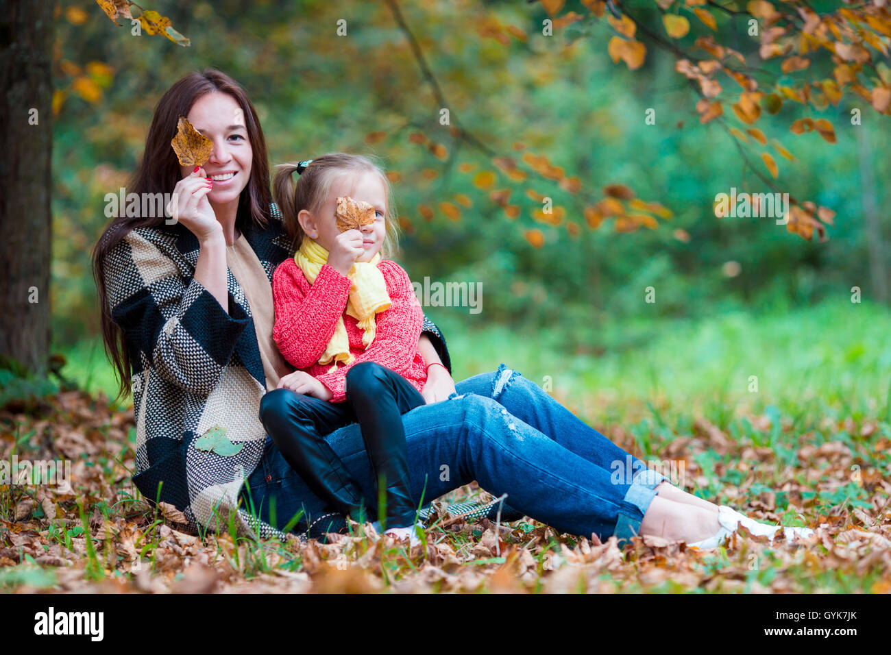 Adorable little girl with mother in autumn park outdoors Stock Photo ...