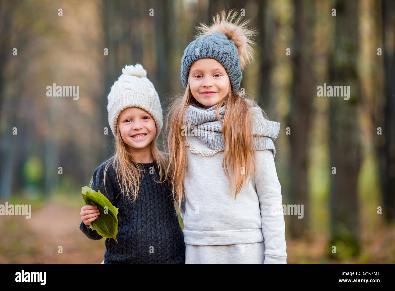 Little adorable girls outdoors at warm sunny autumn day Stock Photo - Alamy
