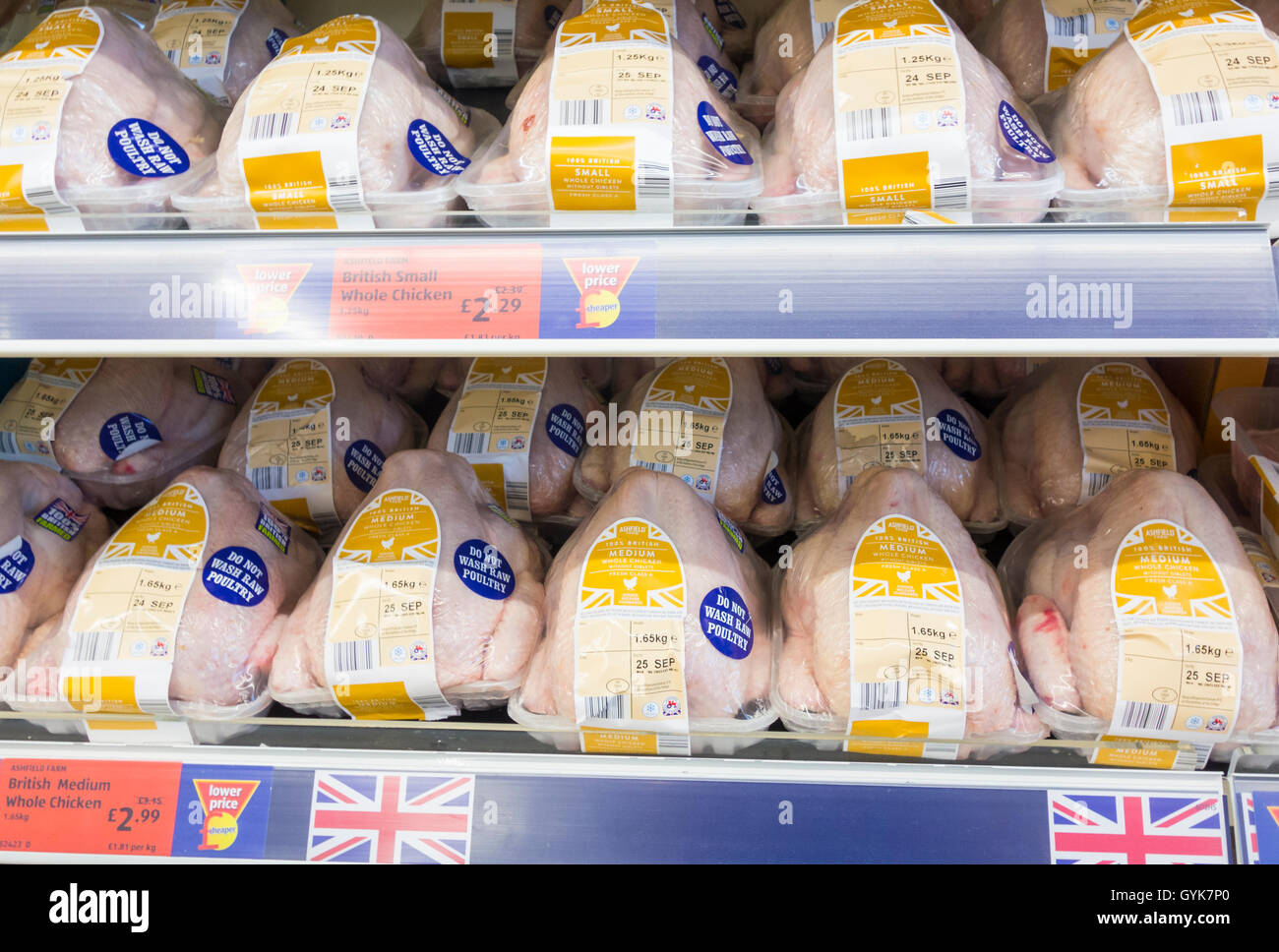 Fresh chickens with do not wash raw poultry stickers in Aldi Stock