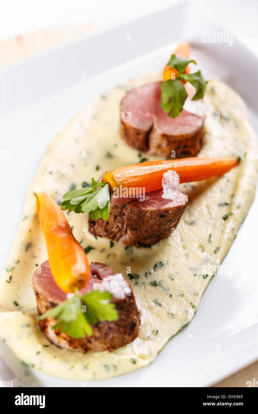 Roast pork tenderloin served with mashed potato and carrots Stock Photo
