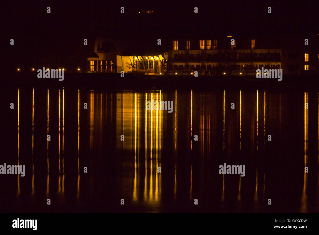 illuminated house reflecting in the lake Chiemsee, Germany, Bavaria, Lake Chiemsee Stock Photo