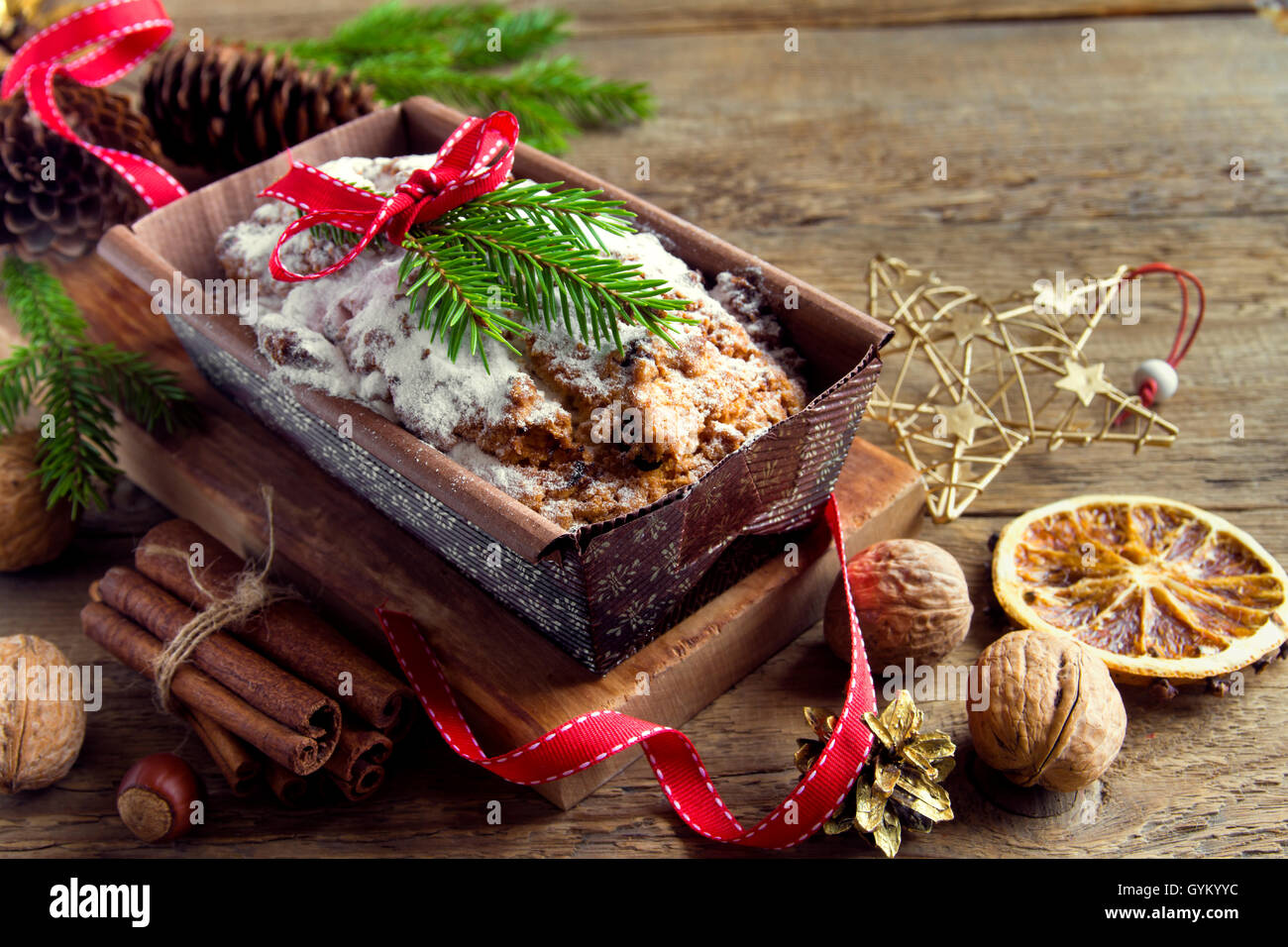 Traditional fruitcake for Christmas with decoration and ornaments - homemade Christmas pastry Stock Photo