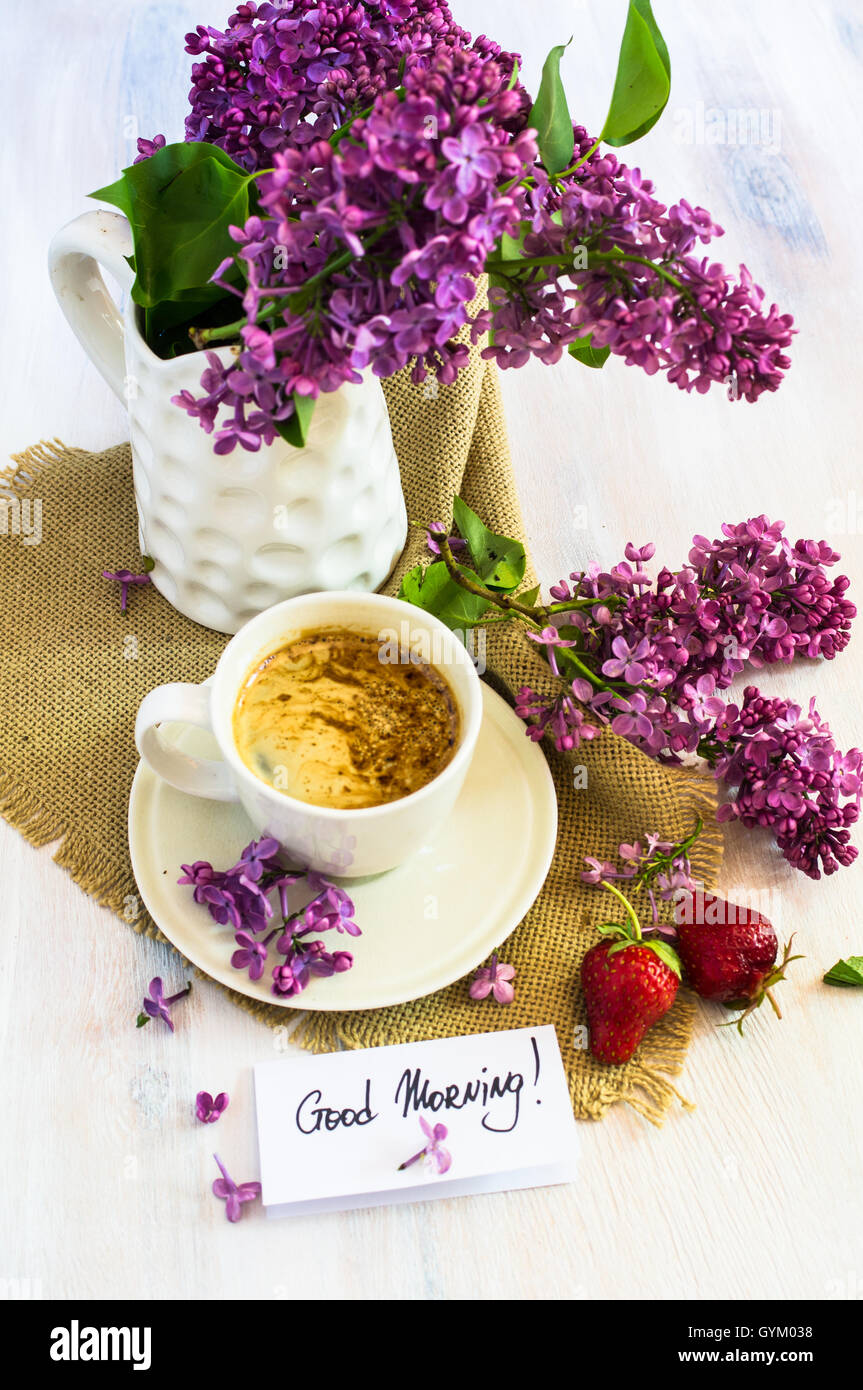 Lilac flowers and cup of coffee with good morning note on rustic ...