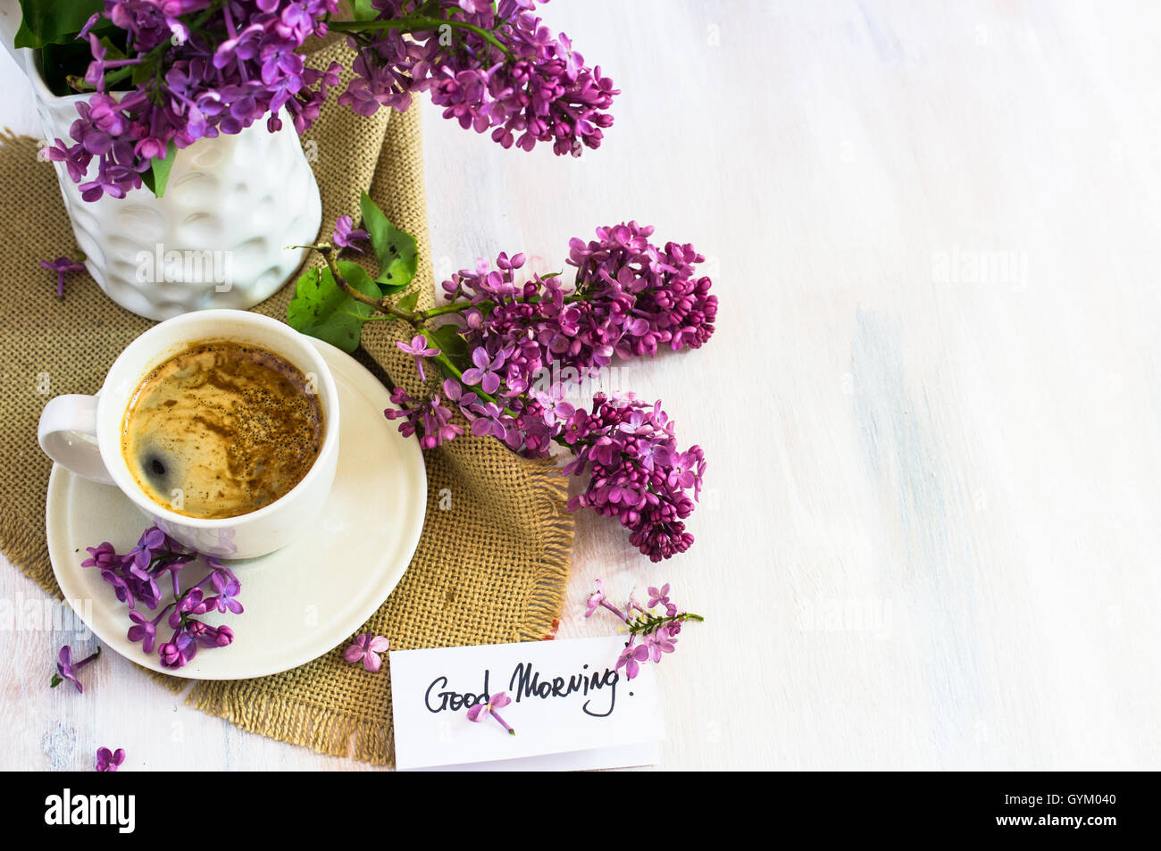 https://c8.alamy.com/comp/GYM040/lilac-flowers-and-cup-of-coffee-with-good-morning-note-on-rustic-wooden-GYM040.jpg