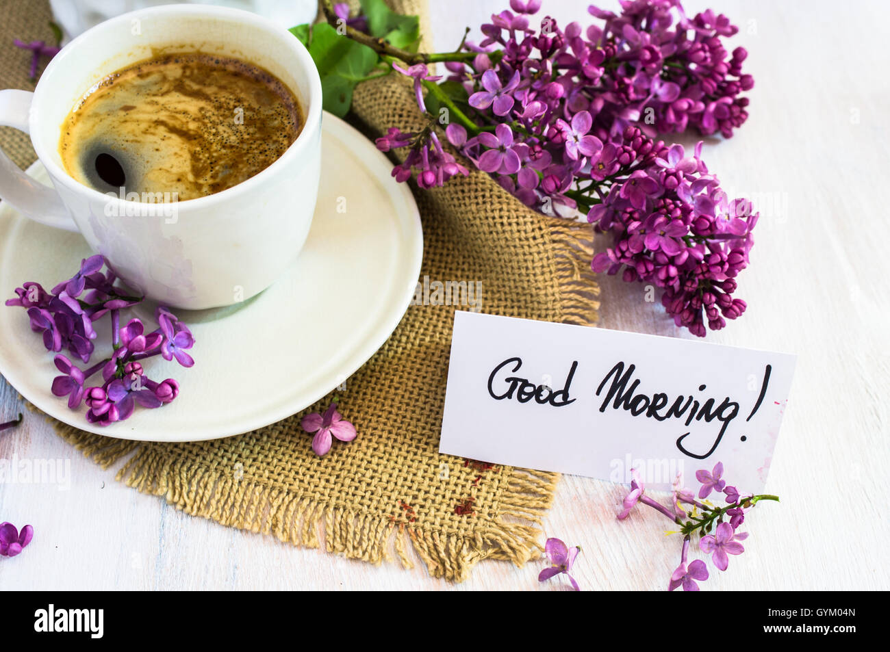 Lilac flowers and cup of coffee with good morning note on rustic ...