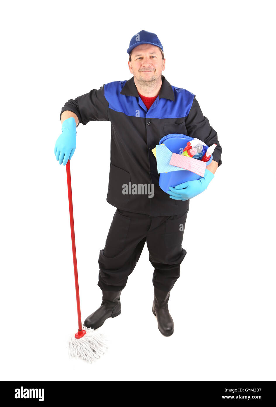 Man in workwear with bucket and mop. Stock Photo