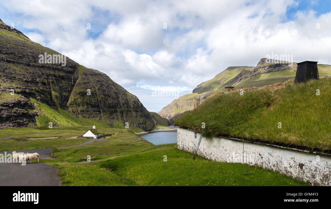 The church and a historic building in Saksun, Streymoy island. Faroe Islands Stock Photo