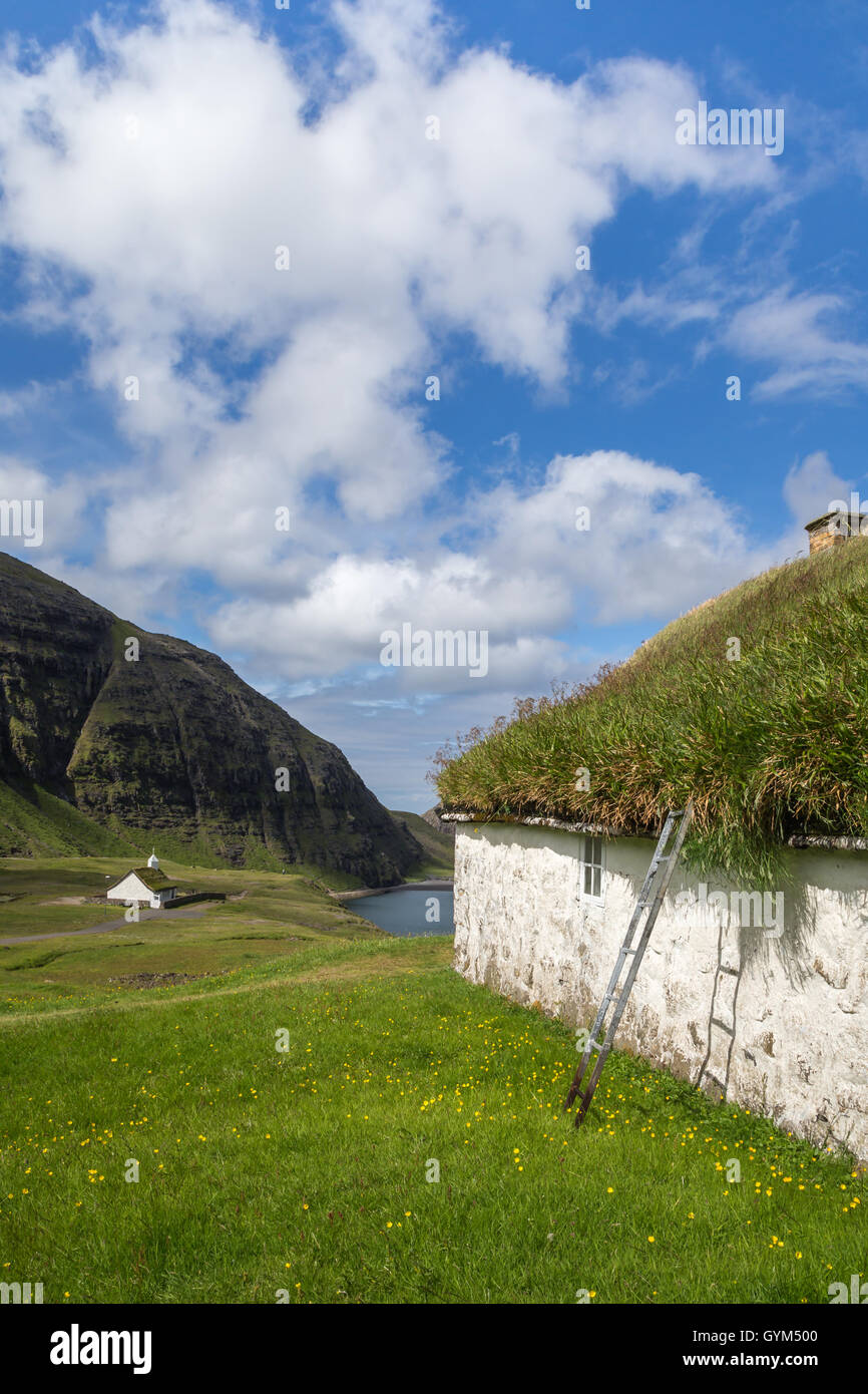 The church and a historic building in Saksun, Streymoy island. Faroe Islands Stock Photo