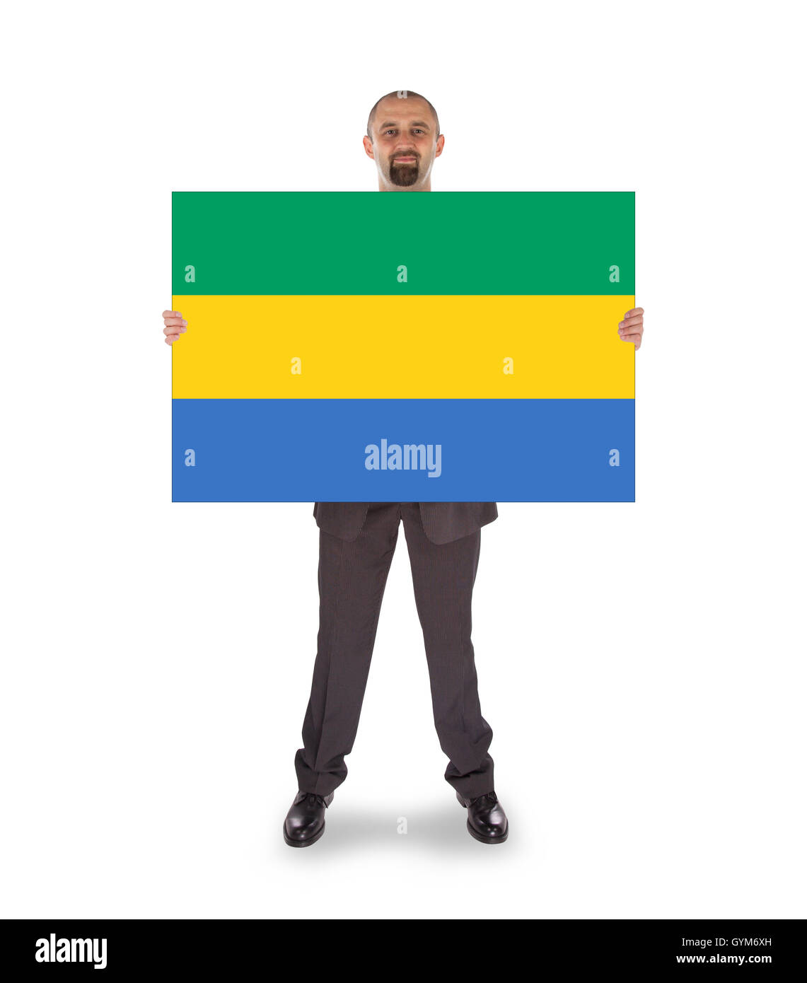 Smiling businessman holding a big card or flag Stock Photo - Alamy