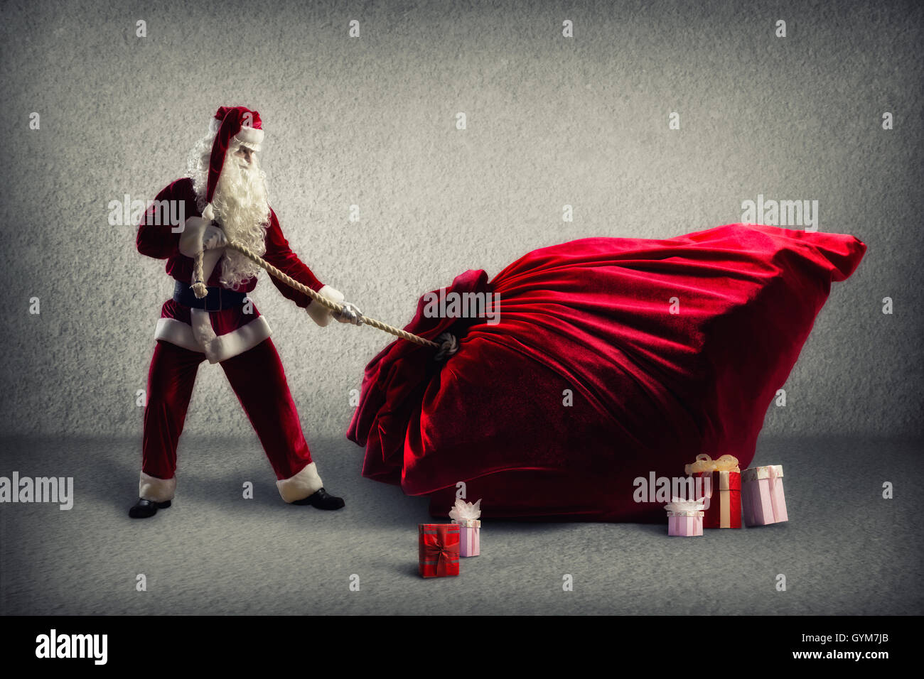 Santa Claus pulls a huge bag of gifts Stock Photo - Alamy