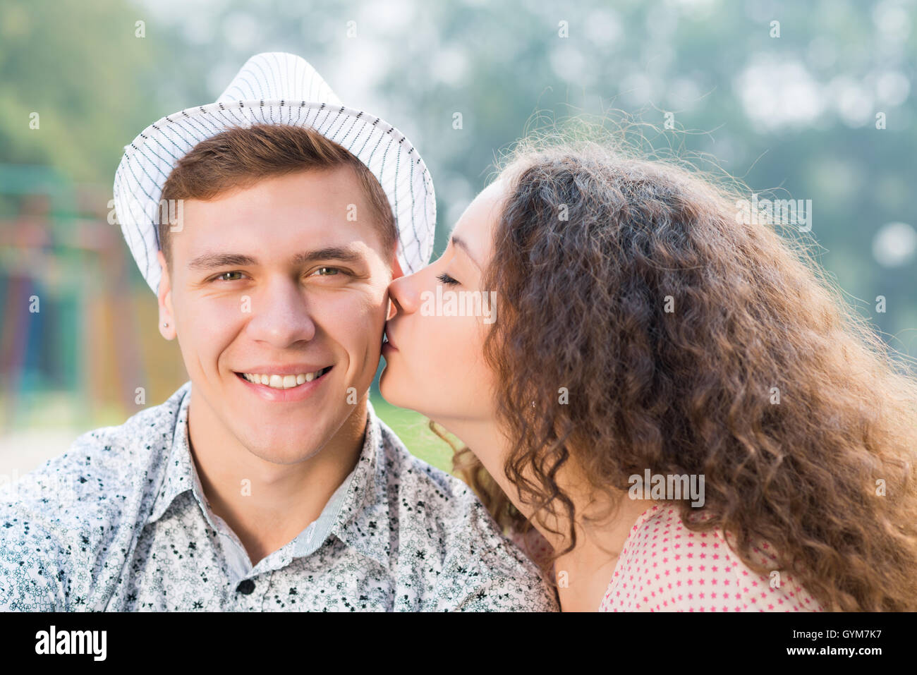 girl kissing a man on the cheek Stock Photo - Alamy
