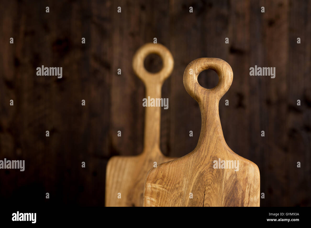 Two unique empty vintage cutting boards on dark rustic wooden background for food blog Stock Photo