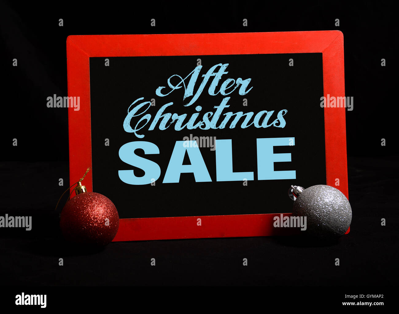 After Christmas Sale banner on chalkboard with balls. Stock Photo