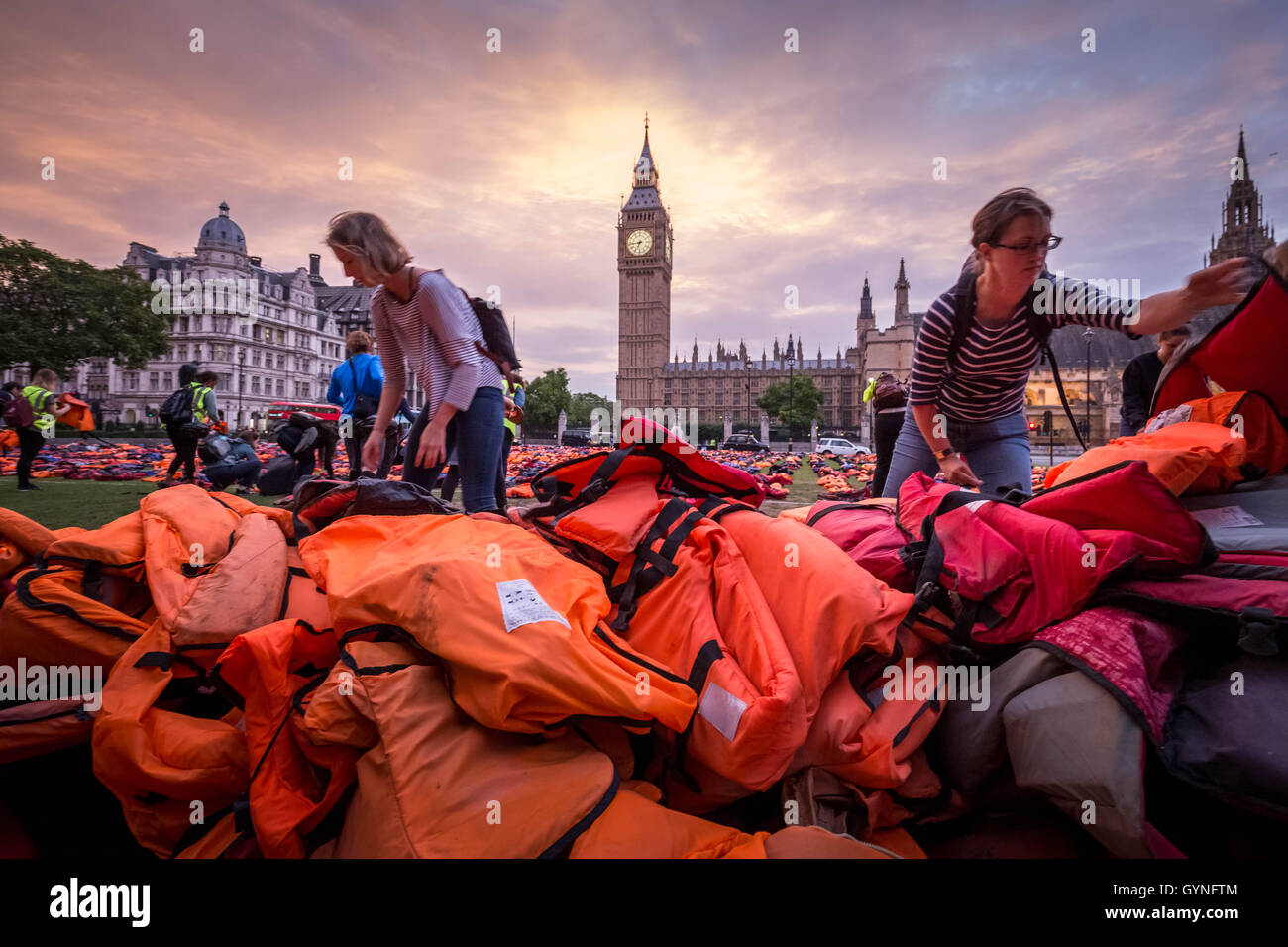 London, UK. 19th September, 2016. ‘Lifejacket Graveyard’ display by refugees and charities in Parliament Square as world leaders meet at United Nations Migration Summit in New York. The lifejackets, many made by people smugglers from cheap non-bouyant materials, were worn by both adult and child refugees who experienced the deadly stretch of sea from Turkey to the Greek island of Chios Credit:  Guy Corbishley/Alamy Live News Stock Photo