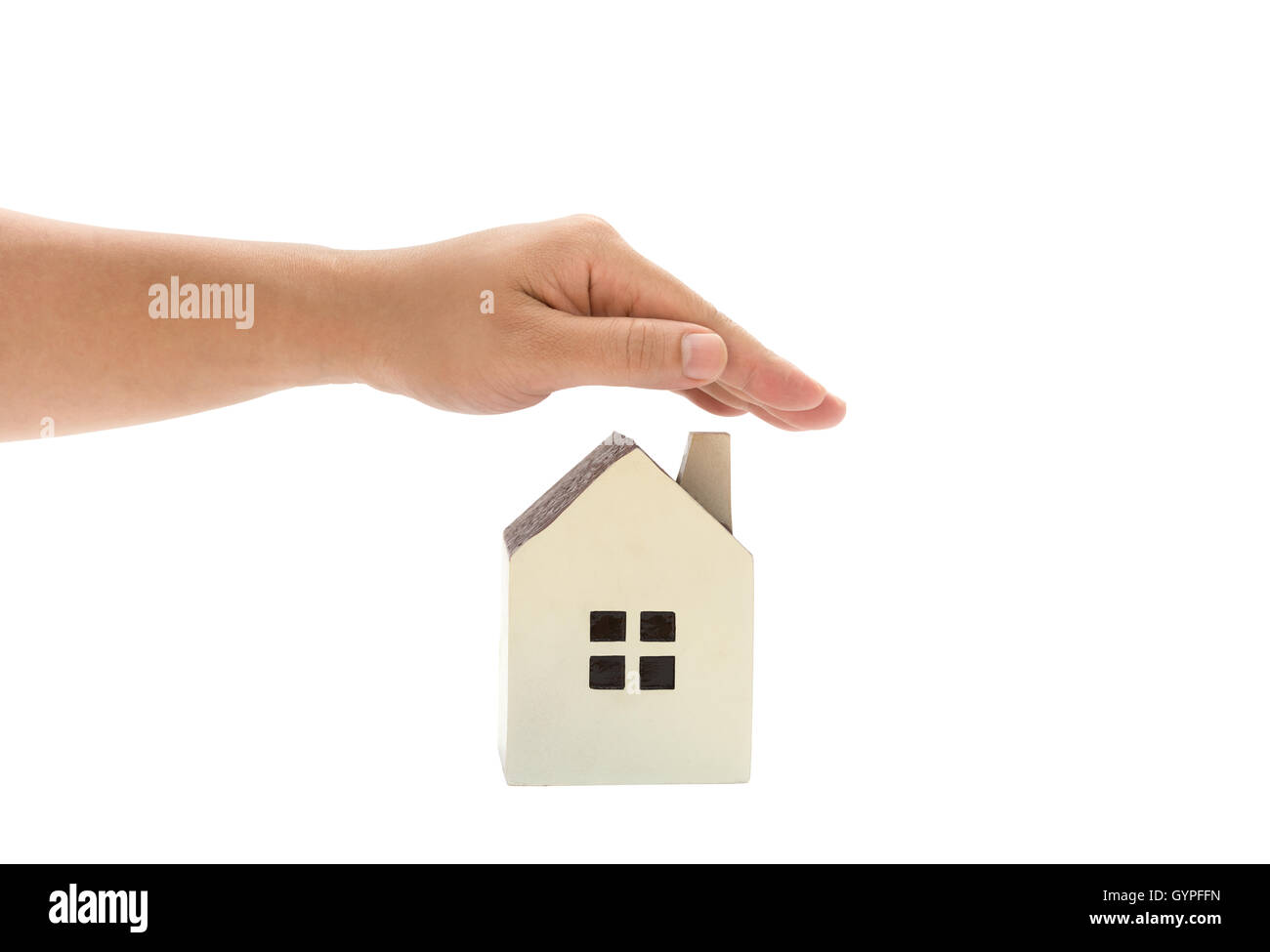 left hand covering a small family house, home insurance concept or representing home ownership Stock Photo