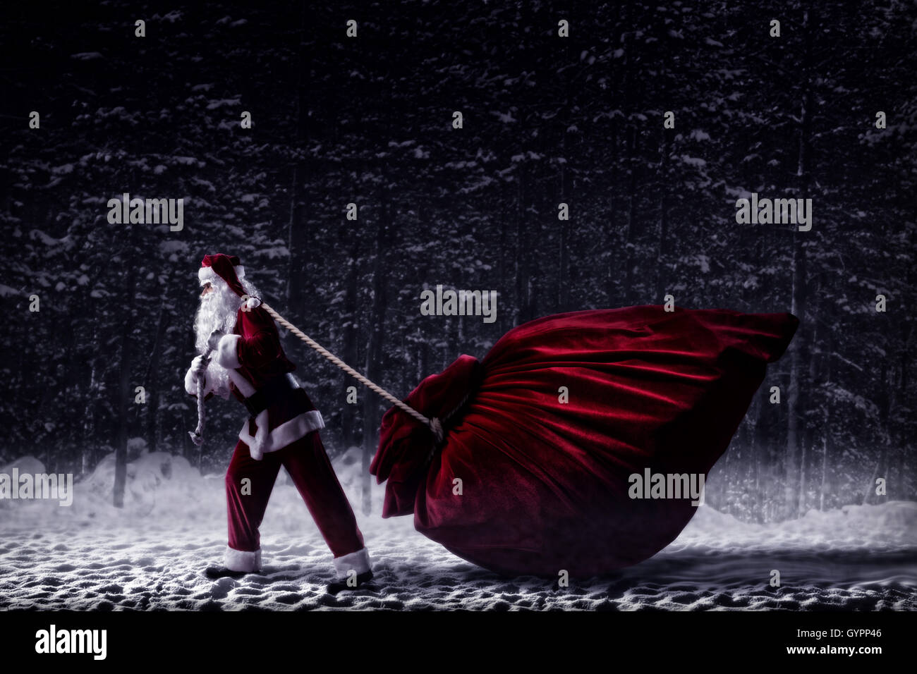 Santa Claus pulls a huge bag of gifts Stock Photo - Alamy