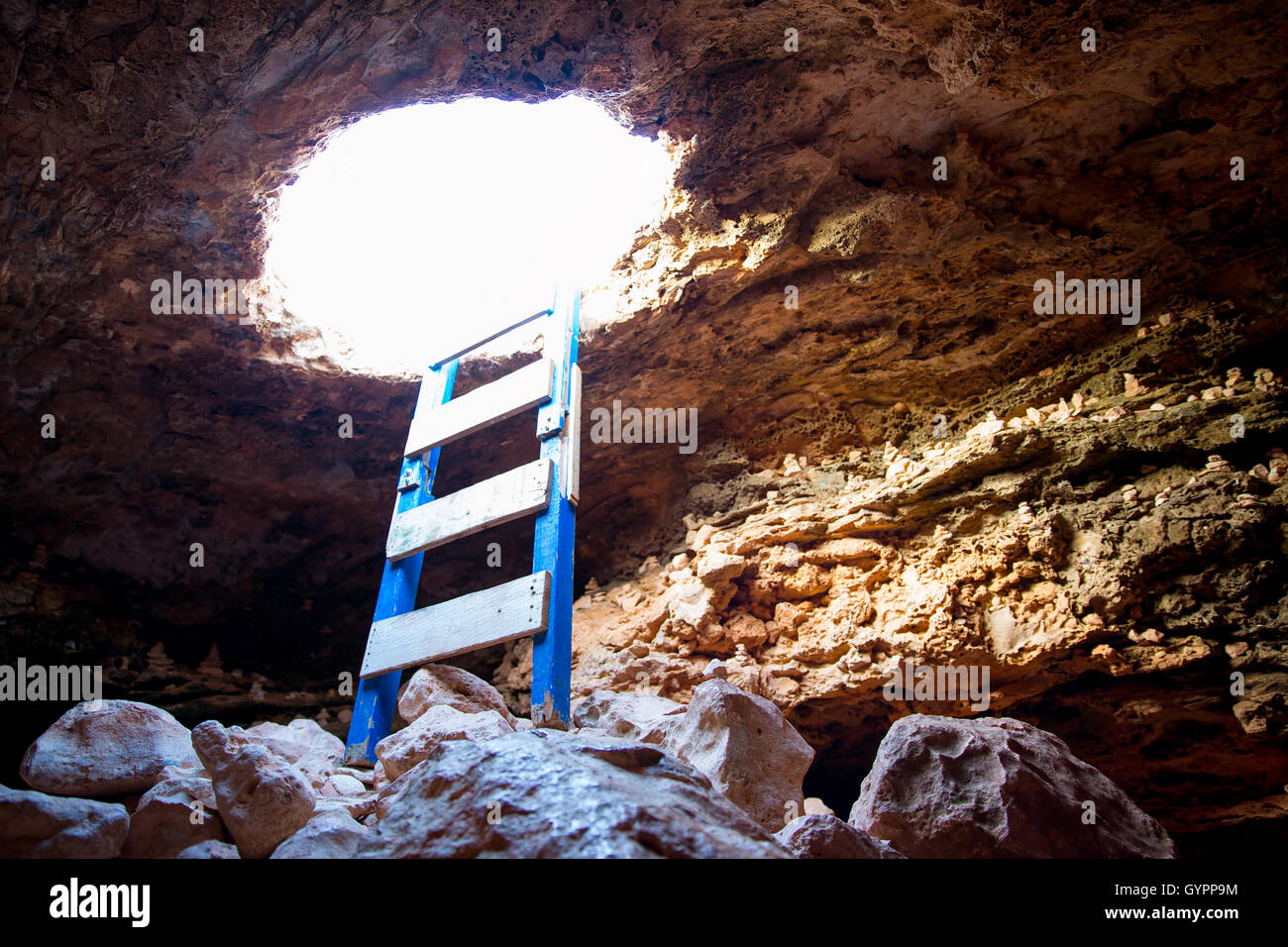 Cave hole entrance with ladder in Barbaria Cape Stock Photo Alamy