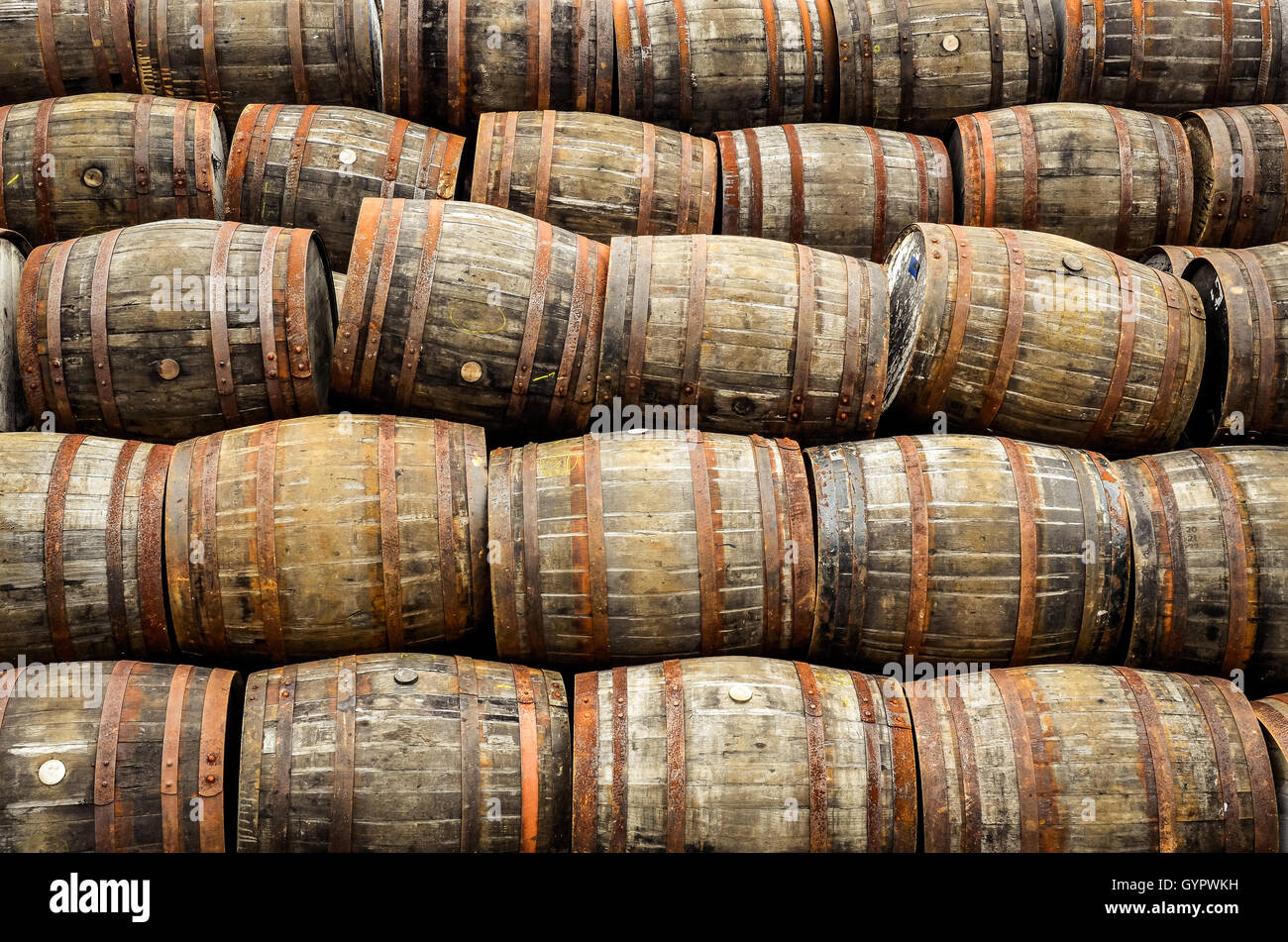 Stacked pile of old whisky and wine wooden barrels Stock Photo