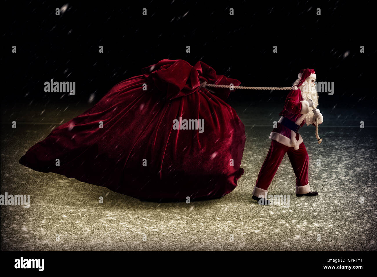 Santa Claus pulls a huge bag of gifts Stock Photo - Alamy