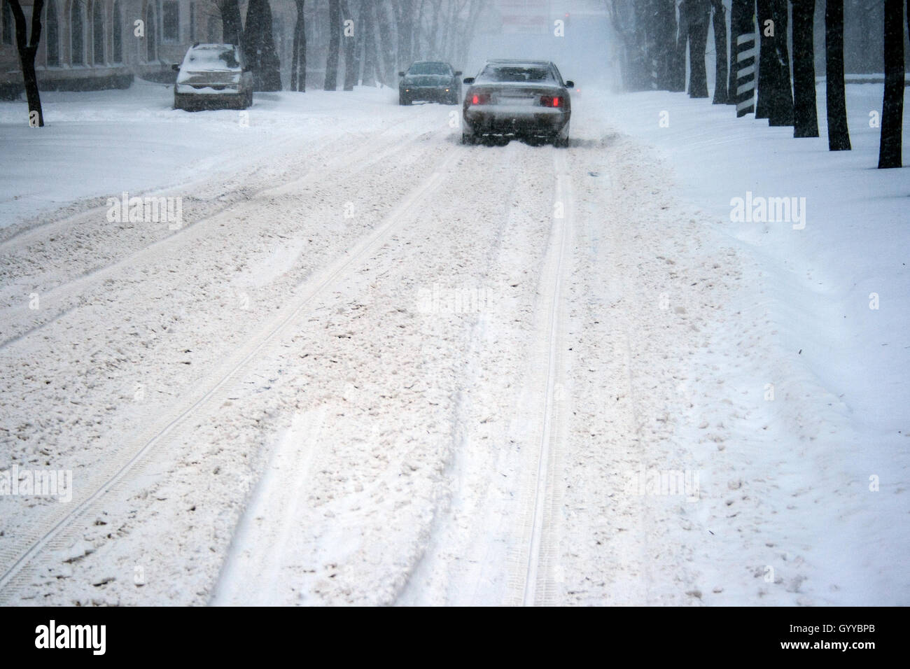Cars driving on slippery road during heavy snowfall Stock Photo
