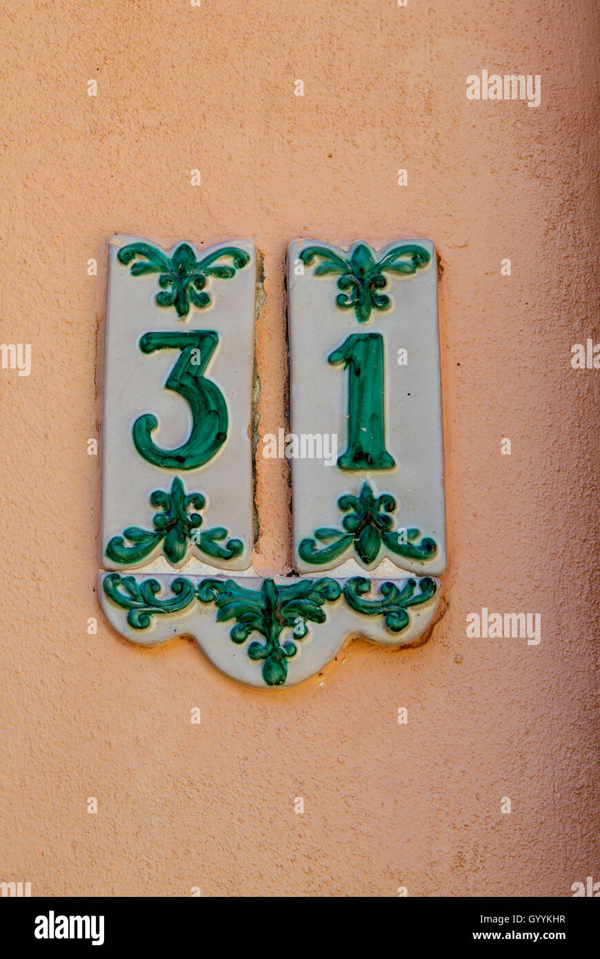 detail of street number Ceramic with old green decorations, thirty-one. Stock Photo