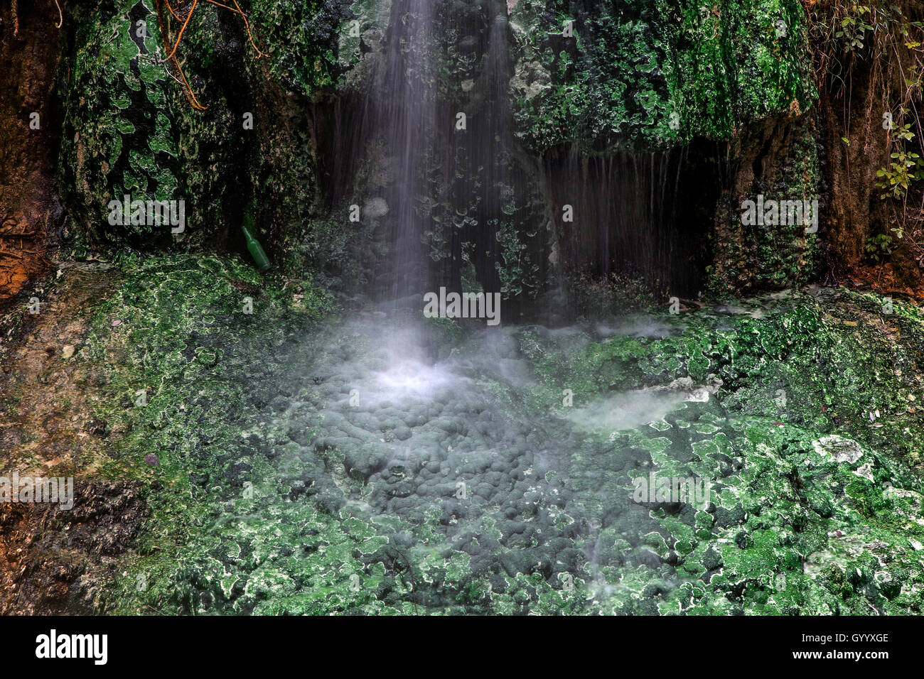 Small waterfall with green mineral deposits, hot springs of Bagni San Filippo, Castiglione d'Orcia, Tuscany, Italy Stock Photo