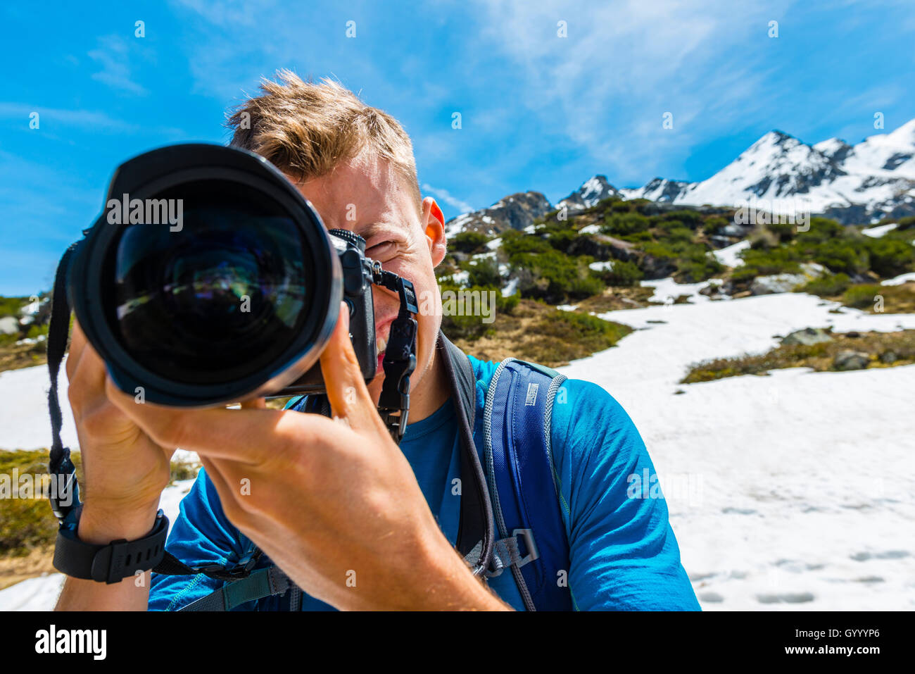 Young man photographing, Rohrmoos-Untertal, Schladming Tauern, Schladming, Styria, Austria Stock Photo
