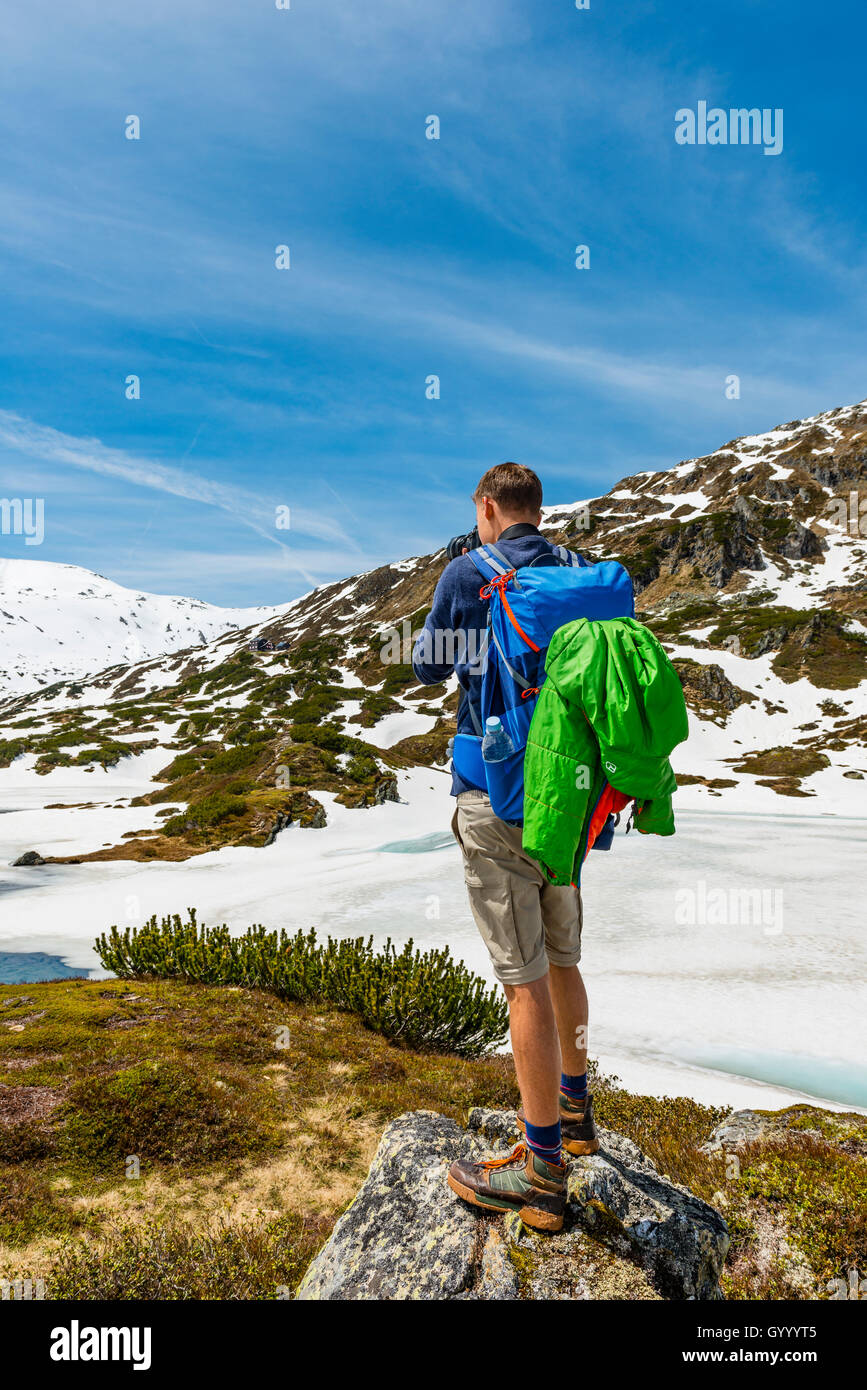 Young man, hiker photographing, Rohrmoos-Untertal, Schladming Tauern, Schladming, Styria, Austria Stock Photo