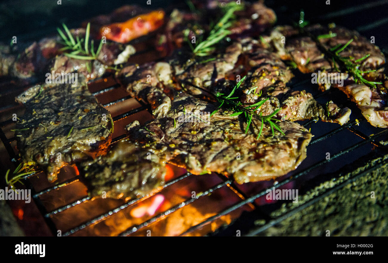 Steaks with rosemary, grilling meat on grates over an open fire Stock Photo Alamy