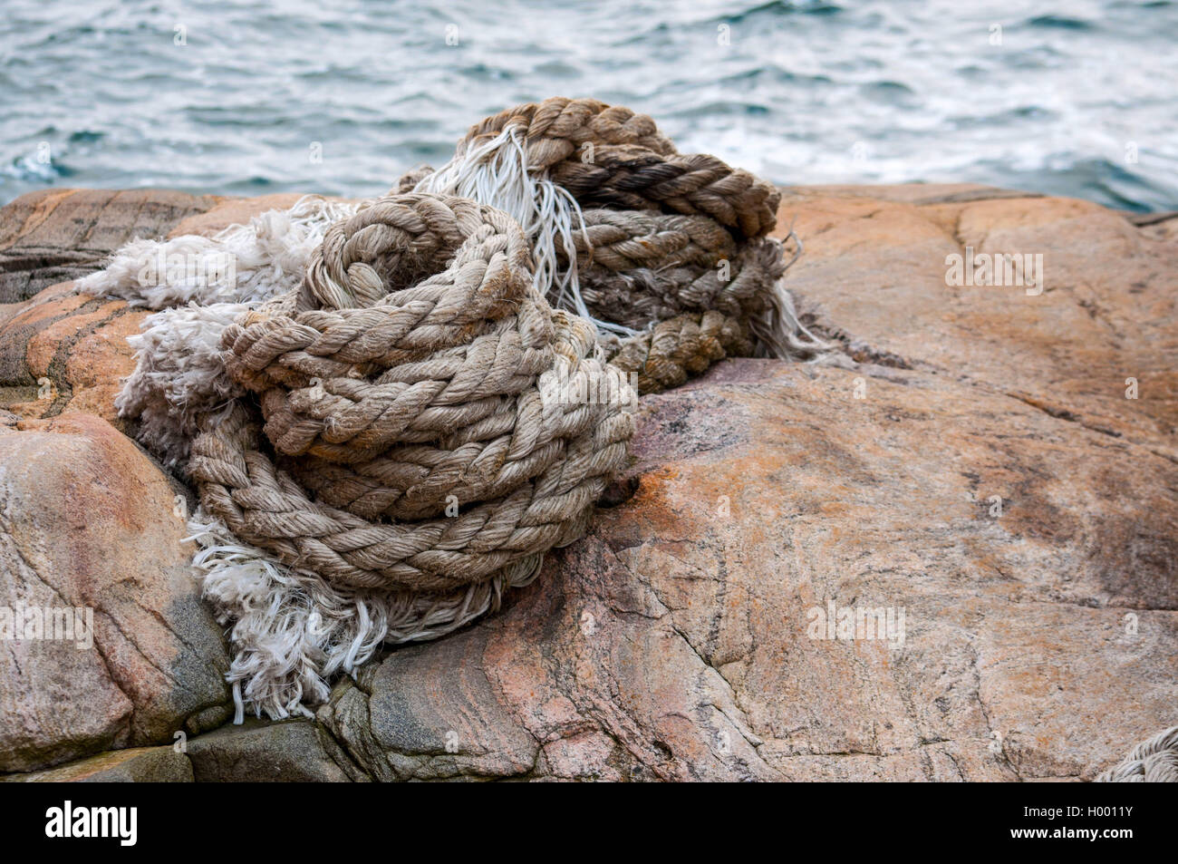 Coiled rope tied the knot on close-up Stock Photo - Alamy