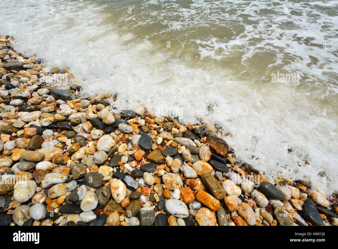 Pebble Beach with seawater at Captain Cook Highway, Australia, Queensland Stock Photo