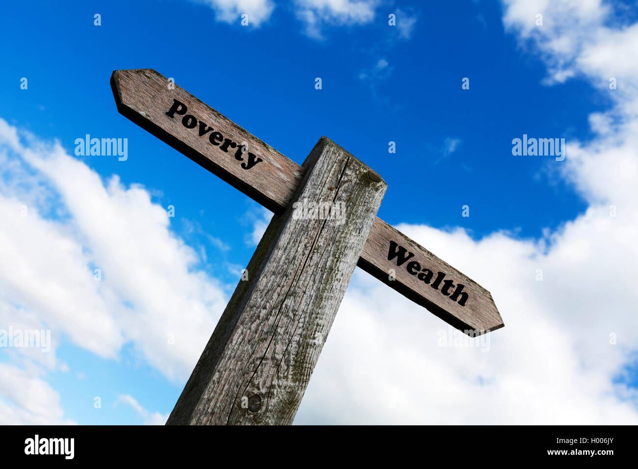 Poverty wealth concept road sign rich poor money debt haves & have nots riches choice choose direction future concepts signs Stock Photo