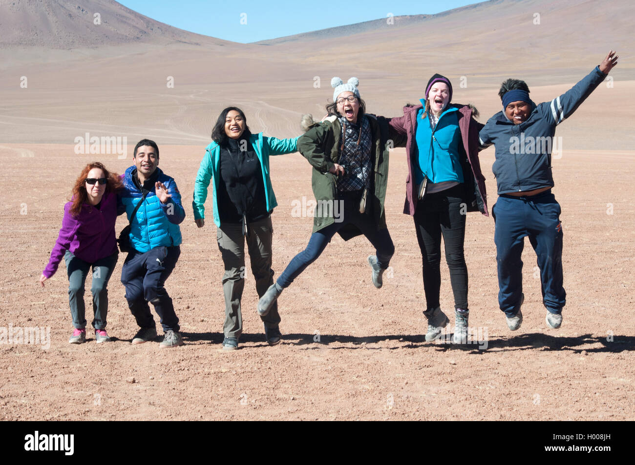 Exuberant tourists posing for the camera en route to the Salar de Uyuni salt flats in Bolivia Stock Photo