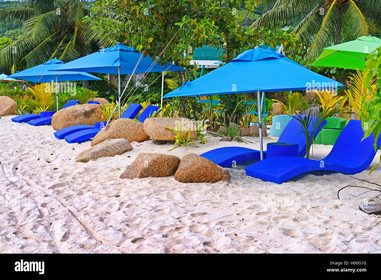 sunshades and sunloungers of a luxus resort on the island La Digue, Seychelles, Insel La Digue Stock Photo