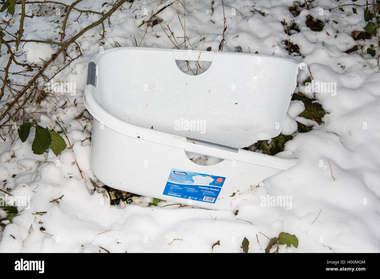 Broken sledges, trays and other pieces of rubbish litter the Roman Amphitheatre in Cirencester, Gloucestsershire Uk. The items have been left after days of sledging and playing in the snow, leaving the area looking like a battleground. Stock Photo