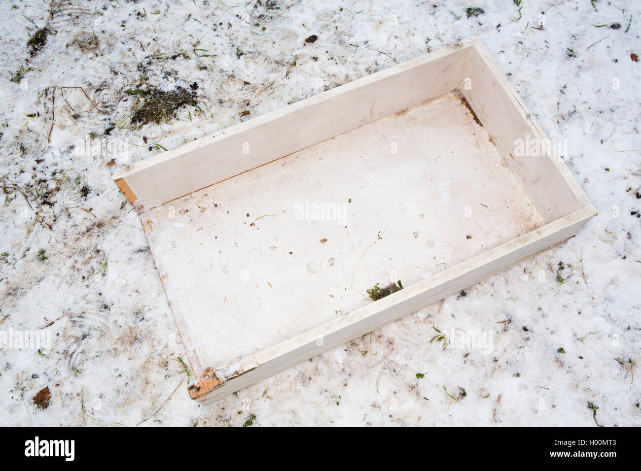 Broken sledges, trays and other pieces of rubbish litter the Roman Amphitheatre in Cirencester, Gloucestsershire Uk. The items have been left after days of sledging and playing in the snow, leaving the area looking like a battleground. Stock Photo