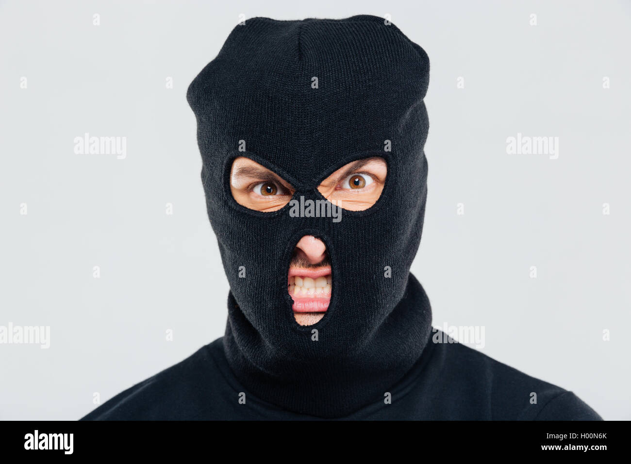 Closeup of angry aggressive young man in balaclava Stock Photo Alamy