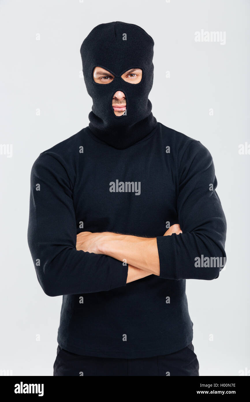 Portrait of man in balaclava standing with arms crossed Stock Photo Alamy