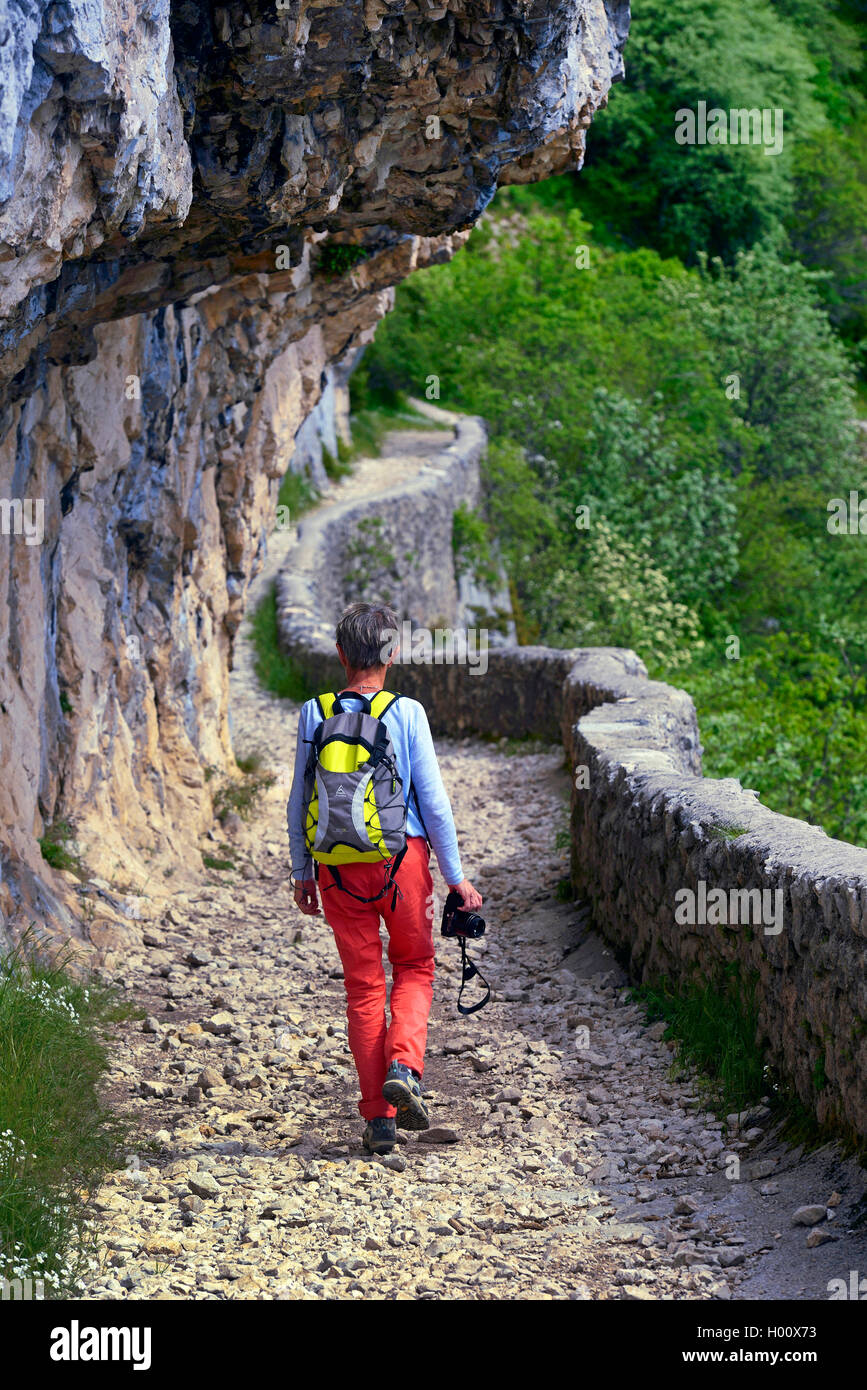 wanderer on mountain trail near the pass of Rousset along a steep face , France, Vercors National Park, Chironne Stock Photo