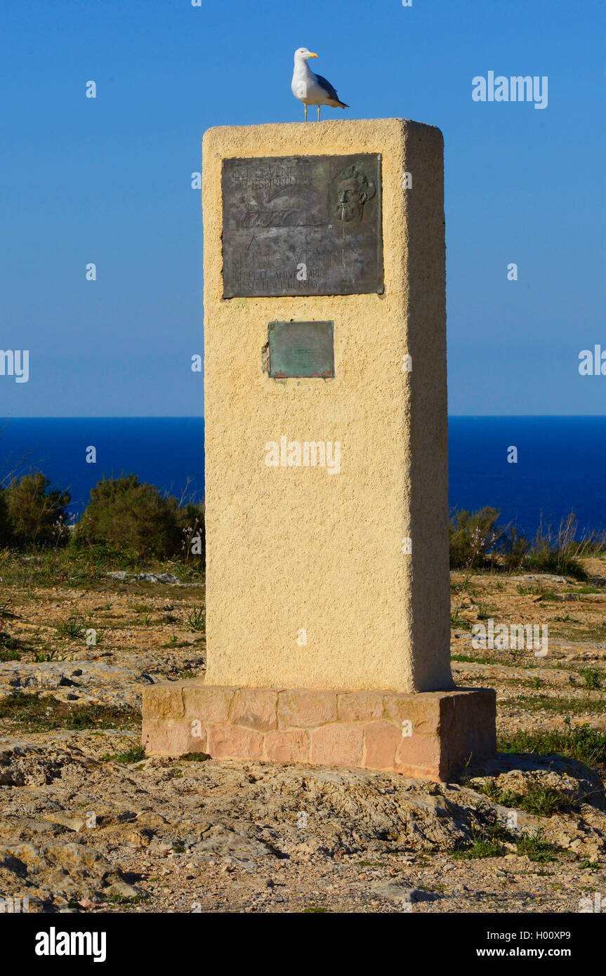 gull sitting on the memorial of Jules Verne at cape Formenteras, Spain, Balearen, Formentera, El Pilar de la Mola Stock Photo