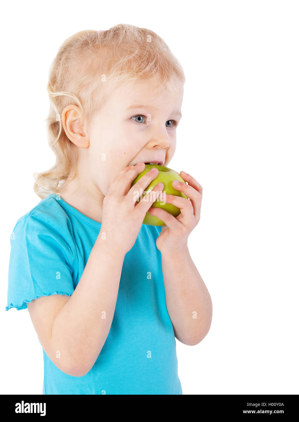 young girl eating green apple Stock Photo