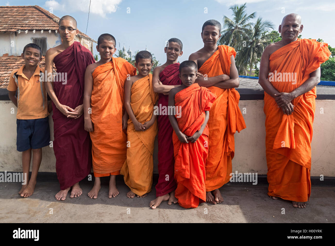 GALLE, SRI LANKA - MARCH 9, 2014: Group of buddhist monks wearing traditional orange robes. Galle is home of Fort Shri Sudarmala Stock Photo