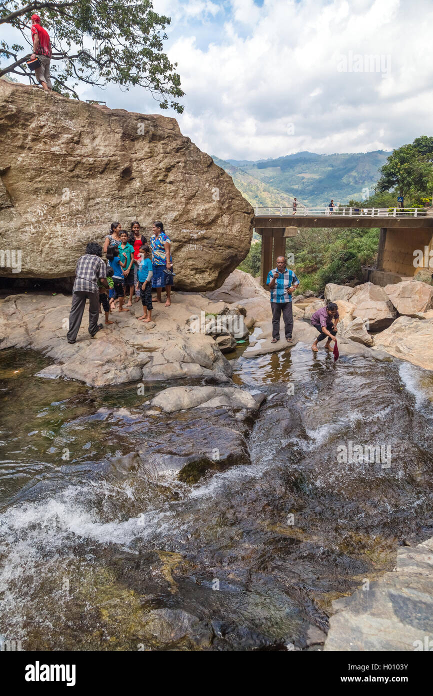 RAVANA FALLS, SRI LANKA - MARCH 2, 2014: Local tourists at Ravana falls, popular sightseeing attraction and one of the widest fa Stock Photo