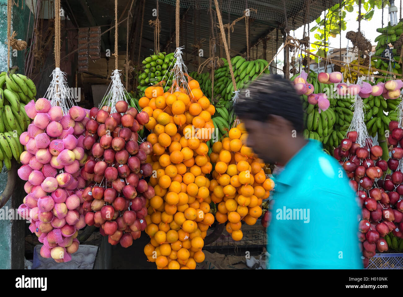 HIKKADUWA, SRI LANKA - FEBRUARY 22, 2014: Local man passing by street fruit stand. Most famous are stands  at Sunday market. Stock Photo