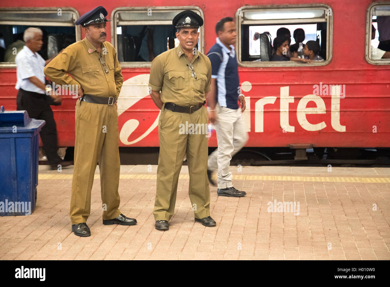 COLOMBO, SRI LANKA - MARCH 12, 2014: Two policemen standing at the train station. The police force has a manpower of approximate Stock Photo